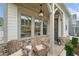 Inviting front porch with stone accents, chairs, and hanging lantern at 1010 Fendley St, Woodstock, GA 30188