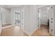 Hallway featuring hardwood floors and doors leading to a bedroom and laundry room at 1010 Fendley St, Woodstock, GA 30188
