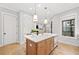 Stylish kitchen island featuring seating and modern pendant lighting at 1010 Fendley St, Woodstock, GA 30188