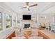 Bright living room with large windows, fireplace, and open floor plan to dining area at 1010 Fendley St, Woodstock, GA 30188