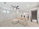 This living room features a ceiling fan, neutral walls, and a comfortable couch at 1010 Fendley St, Woodstock, GA 30188