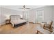 Main bedroom with neutral walls, light hardwood flooring, and shuttered windows at 1010 Fendley St, Woodstock, GA 30188