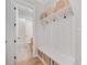 Mudroom features built-in storage bench, hooks, and cubbies near bathroom at 1010 Fendley St, Woodstock, GA 30188