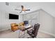 This home office features natural light, a ceiling fan, and an office setup at 1010 Fendley St, Woodstock, GA 30188