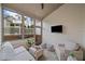 Cozy screened-in porch with comfortable seating and an outdoor TV at 1010 Fendley St, Woodstock, GA 30188