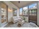 Inviting screened porch with neutral furnishings and views of the backyard at 1010 Fendley St, Woodstock, GA 30188
