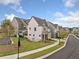 Street view of newly constructed townhomes, landscaped yards, and sidewalks at 1010 Fendley St, Woodstock, GA 30188
