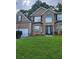 Beautiful brick home featuring an attached garage and a meticulously landscaped front yard at 1962 Bridgestone Cir, Conyers, GA 30012