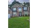 Traditional two-story brick home with large windows and a well-maintained front yard at 1962 Bridgestone Cir, Conyers, GA 30012