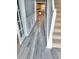 Hallway showcasing modern flooring, wainscoting, and a staircase leading to the upper level at 1962 Bridgestone Cir, Conyers, GA 30012