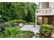 Backyard with patio, lush greenery and mature trees at 3185 Oak Ridge Ln, Loganville, GA 30052
