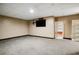 Finished basement featuring carpeted flooring and a wall-mounted television with shelves at 3185 Oak Ridge Ln, Loganville, GA 30052