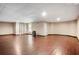 Large basement with hardwood flooring, a window, and a white door at 3185 Oak Ridge Ln, Loganville, GA 30052