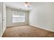 Bedroom with neutral carpet, ceiling fan and window allowing natural light at 3185 Oak Ridge Ln, Loganville, GA 30052