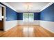 Dining room featuring hardwood floors, white trim, textured ceiling, and decorative lighting at 3185 Oak Ridge Ln, Loganville, GA 30052