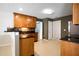Kitchen features wood cabinets, black countertops, modern appliances and a view to other living spaces at 3185 Oak Ridge Ln, Loganville, GA 30052