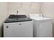 Laundry room featuring Whirlpool washer and dryer with wire shelving above at 3185 Oak Ridge Ln, Loganville, GA 30052