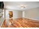 Open living room with hardwood floors flows into the kitchen with updated appliances at 3185 Oak Ridge Ln, Loganville, GA 30052