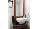 Powder room with pedestal sink, black tile backsplash, and decorative mirror at 3185 Oak Ridge Ln, Loganville, GA 30052
