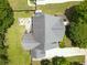 Aerial view of the home's roof, patio with a fire pit, lush lawn, and surrounding mature trees at 330 Bay Grove Rd, Loganville, GA 30052