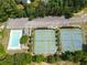 Aerial shot of the pool and tennis courts near a parking lot and mature trees at 330 Bay Grove Rd, Loganville, GA 30052