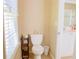Cozy bathroom featuring a toilet with beige walls, decorative accessories, and a small vanity at 330 Bay Grove Rd, Loganville, GA 30052