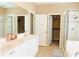 Spacious bathroom featuring double sinks, white cabinets and a glass-enclosed shower at 330 Bay Grove Rd, Loganville, GA 30052