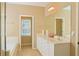 Bright bathroom featuring double sinks, white cabinets and a separate bathtub at 330 Bay Grove Rd, Loganville, GA 30052