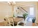Stylish dining room with adjacent staircase, ideal for entertaining guests at 330 Bay Grove Rd, Loganville, GA 30052