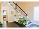 Inviting entryway with dark wood floors, statement staircase and bright natural light at 330 Bay Grove Rd, Loganville, GA 30052
