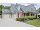 Charming two-story home with a manicured lawn, three car garage and inviting front porch with classic columns at 330 Bay Grove Rd, Loganville, GA 30052