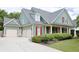 Charming two-story home with a manicured lawn, three car garage and inviting front porch with classic columns at 330 Bay Grove Rd, Loganville, GA 30052