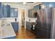 Updated kitchen with gray cabinets, stainless steel appliances, and hardwood floors at 330 Bay Grove Rd, Loganville, GA 30052