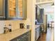 Modern kitchen featuring granite countertops and sleek appliances with view to dining at 330 Bay Grove Rd, Loganville, GA 30052