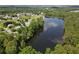 Wide aerial view of a lake surrounded by houses and mature trees at 330 Bay Grove Rd, Loganville, GA 30052