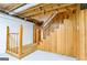 Wooden stairs with railings leading to the basement, featuring paneled walls and overhead ducts at 3421 Fawn Trl, Marietta, GA 30066