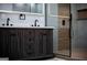 Close-up of a stylish bathroom vanity with double sinks, quartz countertop, and decorative wood accents at 3421 Fawn Trl, Marietta, GA 30066