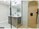 Modern bathroom with double vanity, walk-in shower with wood paneling, and sleek fixtures at 3421 Fawn Trl, Marietta, GA 30066