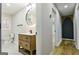 Bathroom featuring a modern vanity with round mirror and wood-look floor at 3421 Fawn Trl, Marietta, GA 30066