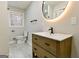 Updated bathroom with a sleek vanity, modern fixtures, and a stylish, illuminated round mirror at 3421 Fawn Trl, Marietta, GA 30066