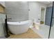 Contemporary bathroom featuring a standalone tub, toilet, and stylish gray door at 3421 Fawn Trl, Marietta, GA 30066
