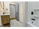 Well-lit bathroom with a modern vanity, round mirror, tub-shower combo, and ample storage space at 3421 Fawn Trl, Marietta, GA 30066