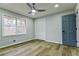 Charming bedroom with light gray walls, hardwood floors, ceiling fan, closet, and blue door at 3421 Fawn Trl, Marietta, GA 30066