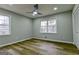 A bright bedroom with two windows, ceiling fan, and closet, offering ample natural light and storage at 3421 Fawn Trl, Marietta, GA 30066