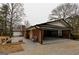 Attached carport with brick accent walls with outdoor seating and landscaping nearby at 3421 Fawn Trl, Marietta, GA 30066