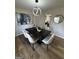 Cozy dining room boasting modern chandelier, refinished floors, and decorative wall art at 3421 Fawn Trl, Marietta, GA 30066