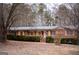 Charming brick home with covered porch, wooden shutters, and mature landscaping at 3421 Fawn Trl, Marietta, GA 30066