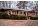 Cozy brick home offering shutters, wooden stairs, and trimmed bushes at 3421 Fawn Trl, Marietta, GA 30066