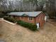 Brick house from an aerial view, showcasing garage, driveway, and mature greenery at 3421 Fawn Trl, Marietta, GA 30066