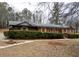 Charming brick home featuring green hedges, wooden shutters, and well-manicured yard at 3421 Fawn Trl, Marietta, GA 30066